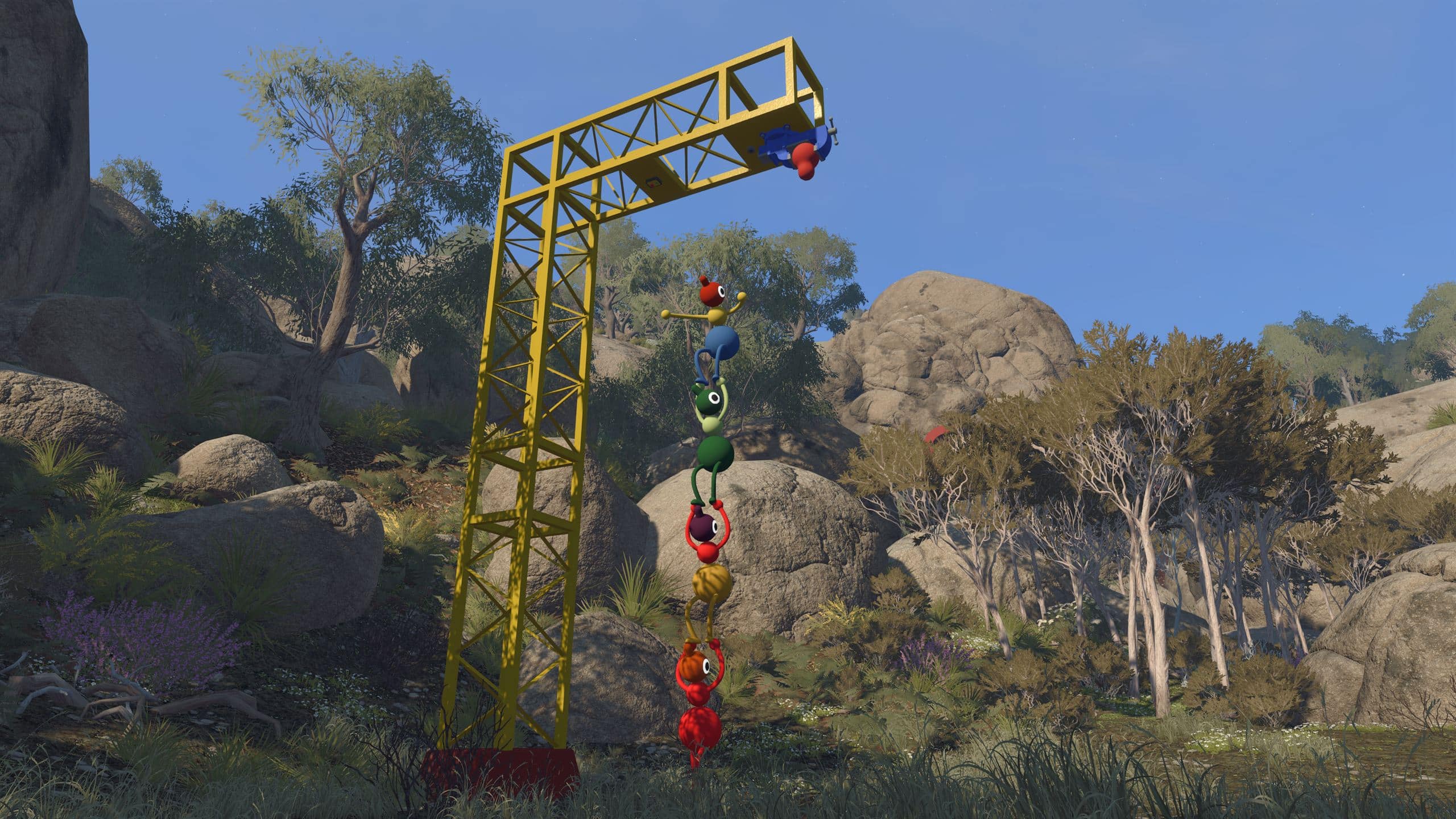 A chain of seven Big Walk players hanging from a tall yellow tower